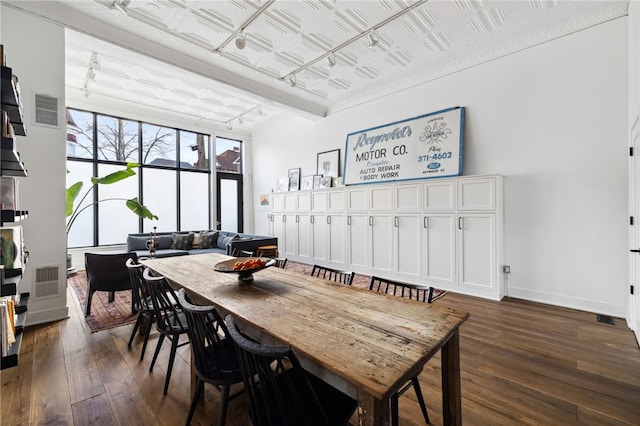 dining area featuring baseboards, visible vents, an ornate ceiling, dark wood-type flooring, and track lighting