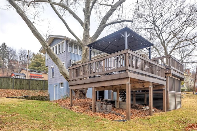 rear view of house with a yard and a wooden deck