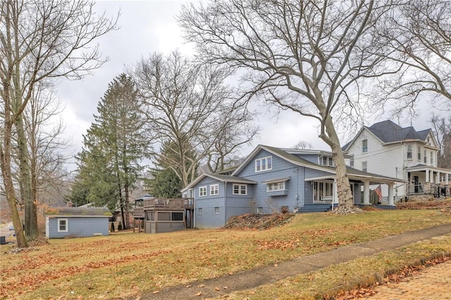 view of front facade featuring a front yard and an outbuilding