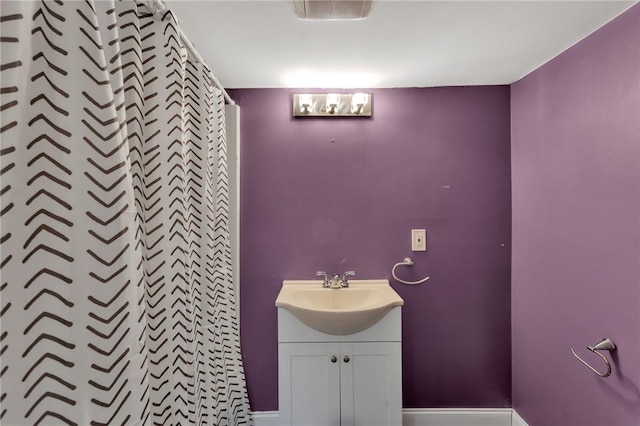 bathroom with walk in shower and vanity