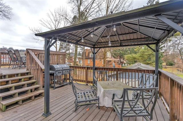 wooden terrace with grilling area and a gazebo