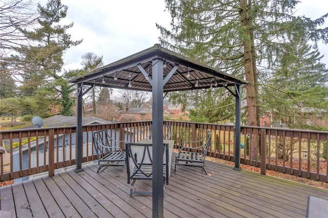 wooden terrace featuring a gazebo