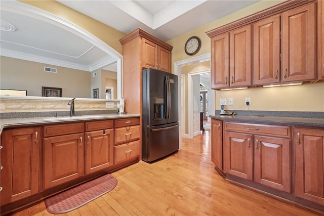 1012 Country Club Dr, Penn Twp Wml, PA 15644 - kitchen with visible vents, brown cabinetry, black fridge, light wood-type flooring, and a sink