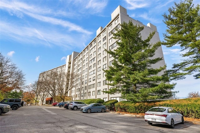 view of building exterior with uncovered parking