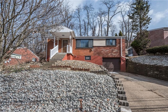 view of front of property with concrete driveway, brick siding, and an attached garage