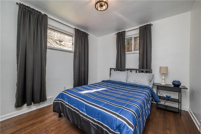 bedroom with baseboards and wood finished floors