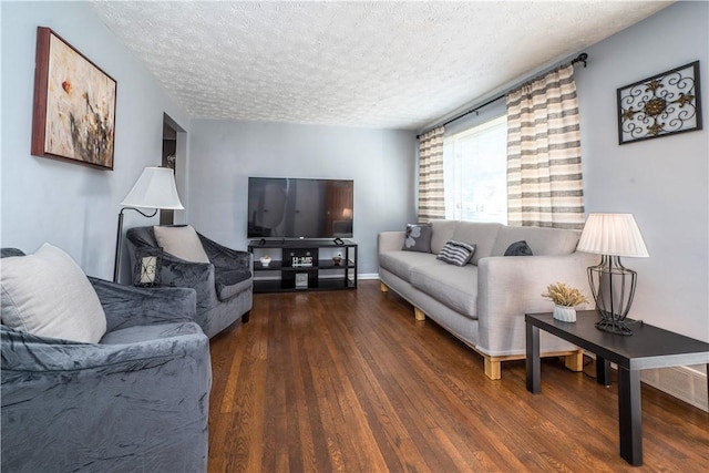 living area with a textured ceiling and wood finished floors