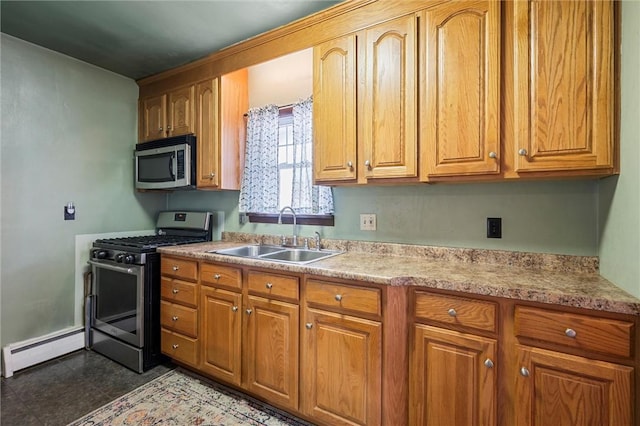 kitchen with stainless steel appliances, a sink, light countertops, baseboard heating, and brown cabinets