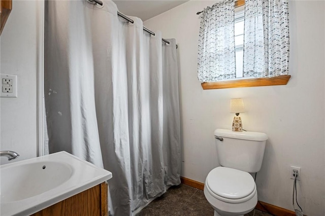 bathroom with baseboards, a shower with shower curtain, toilet, tile patterned flooring, and a sink