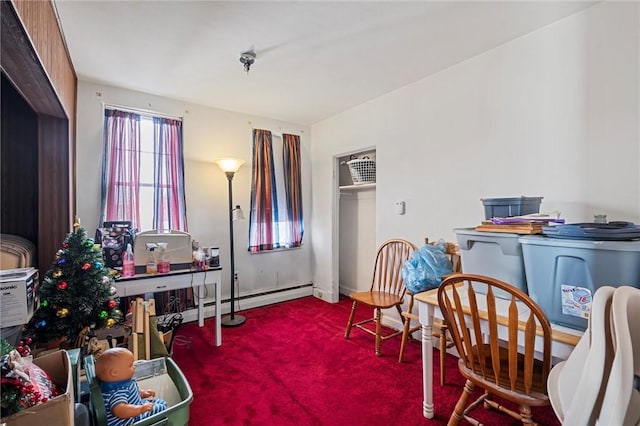 interior space featuring carpet, a baseboard heating unit, and baseboards