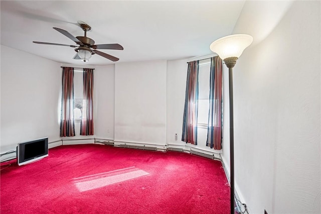 carpeted empty room featuring a ceiling fan