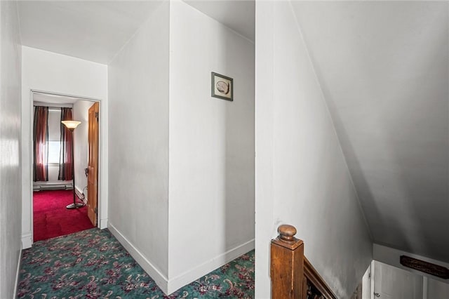 hallway with carpet flooring and baseboards