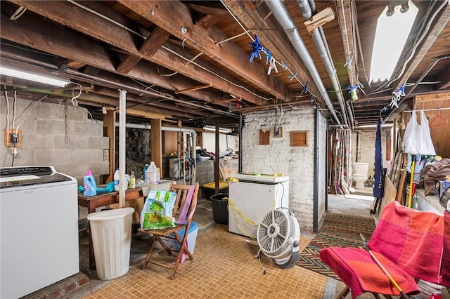 unfinished basement featuring washer / clothes dryer