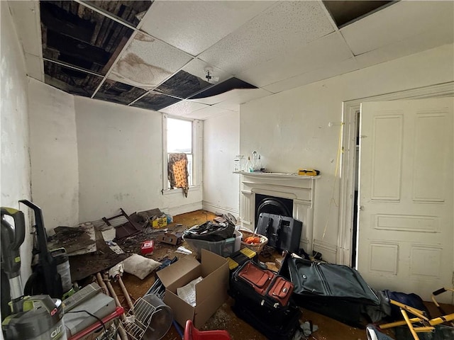 misc room with a drop ceiling and a fireplace