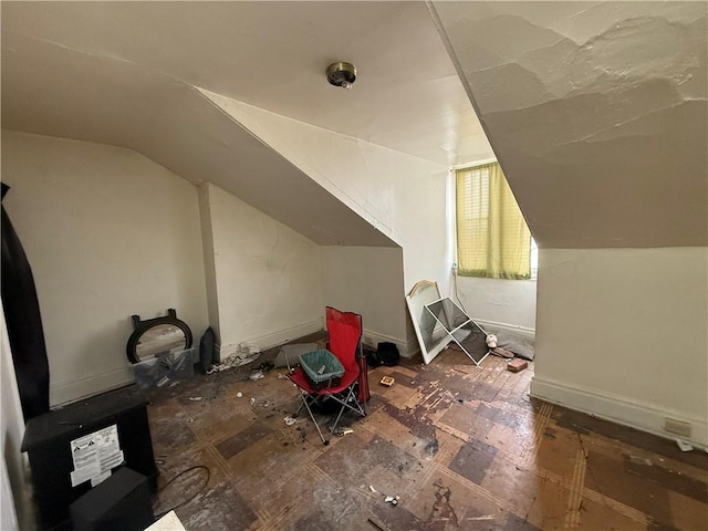 bonus room featuring lofted ceiling and baseboards