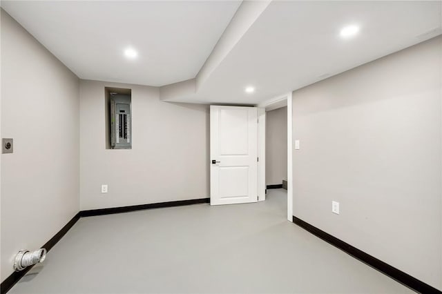 finished basement featuring recessed lighting, electric panel, and baseboards