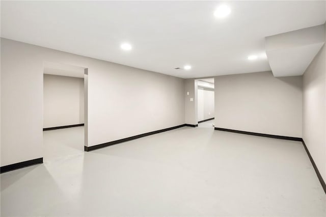 finished basement with baseboards and recessed lighting