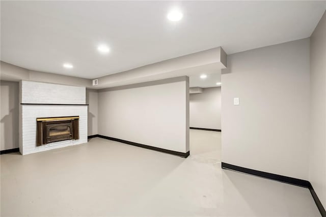 unfurnished living room featuring concrete floors, recessed lighting, and baseboards