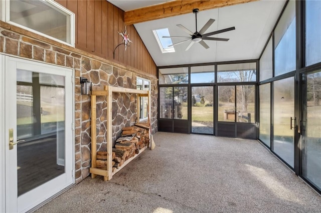 unfurnished sunroom featuring ceiling fan and lofted ceiling with skylight