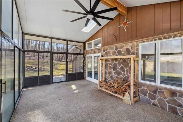 unfurnished sunroom with vaulted ceiling with skylight and ceiling fan