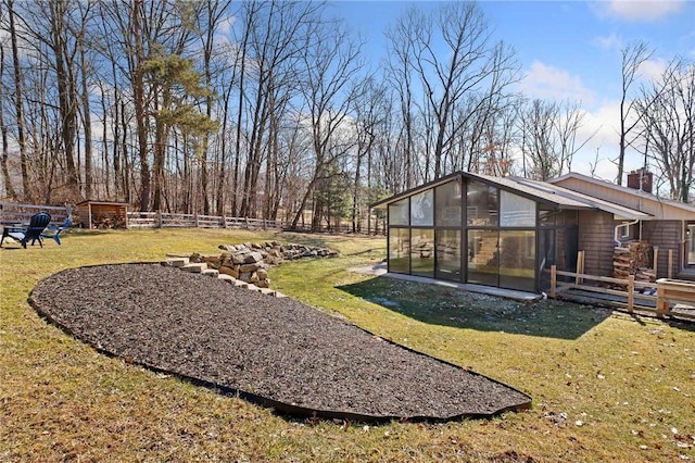 view of yard featuring an outbuilding and fence