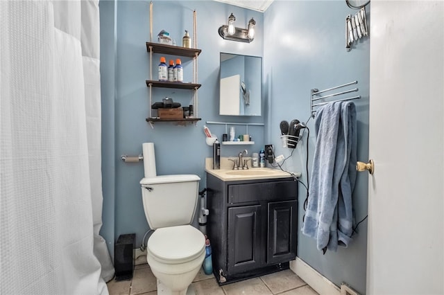 bathroom featuring a shower with shower curtain, toilet, vanity, tile patterned flooring, and baseboards