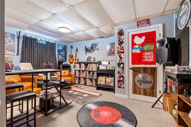 interior space with a drop ceiling and carpet flooring