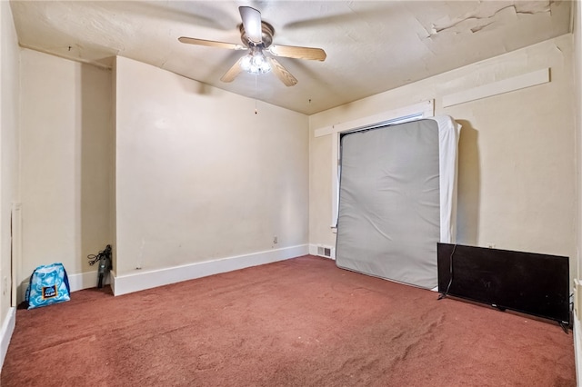 unfurnished bedroom featuring carpet, baseboards, and ceiling fan