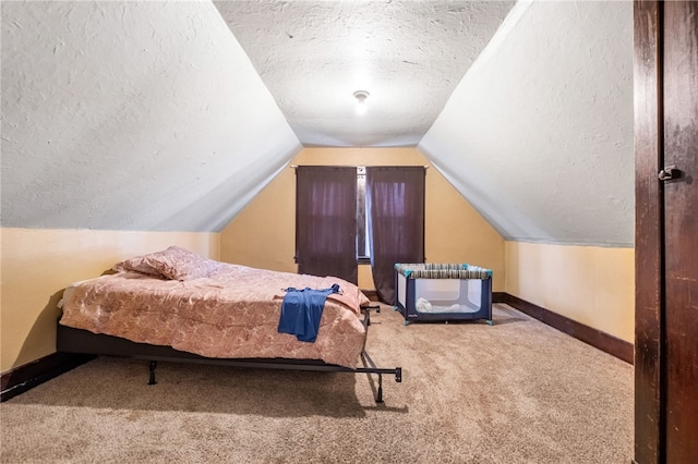 carpeted bedroom featuring lofted ceiling, a textured ceiling, and baseboards