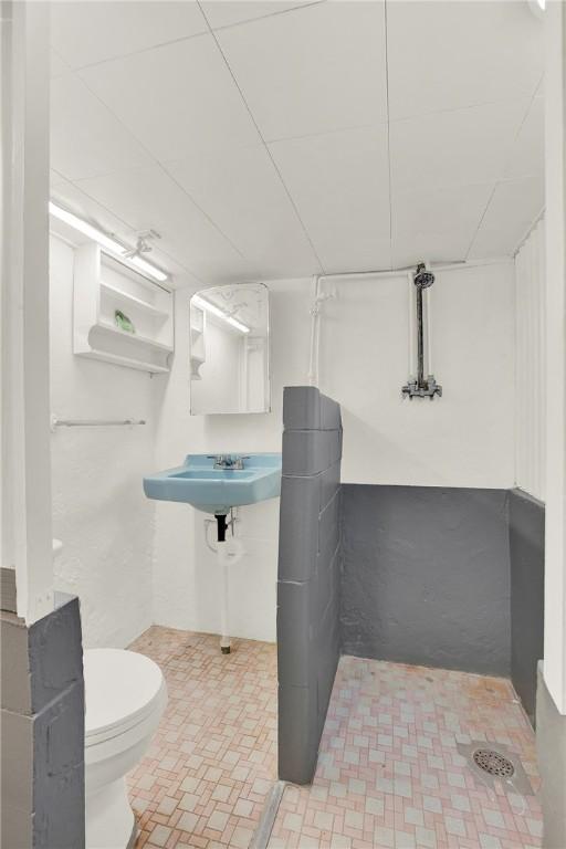 half bath with a sink and toilet