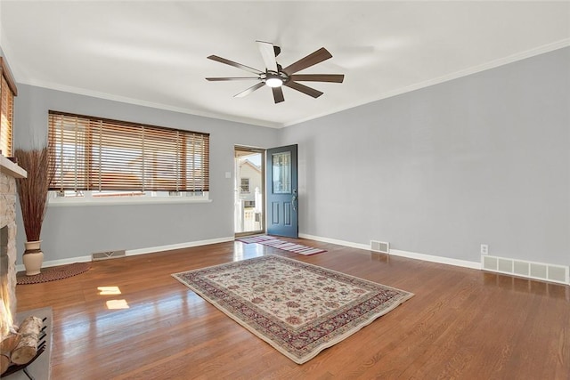 entrance foyer with baseboards, visible vents, and wood finished floors