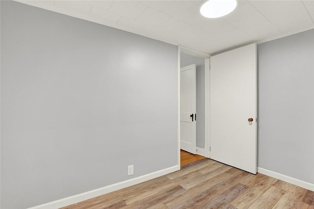 empty room featuring wood finished floors and baseboards