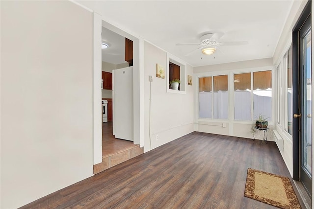 unfurnished sunroom with a ceiling fan