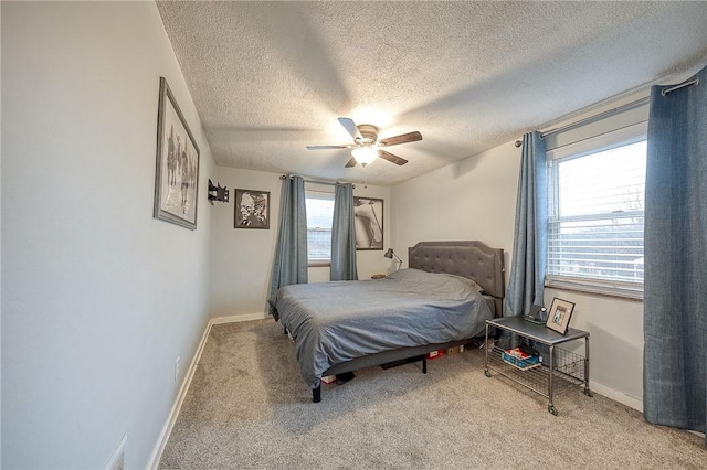 bedroom with light carpet, baseboards, and a ceiling fan