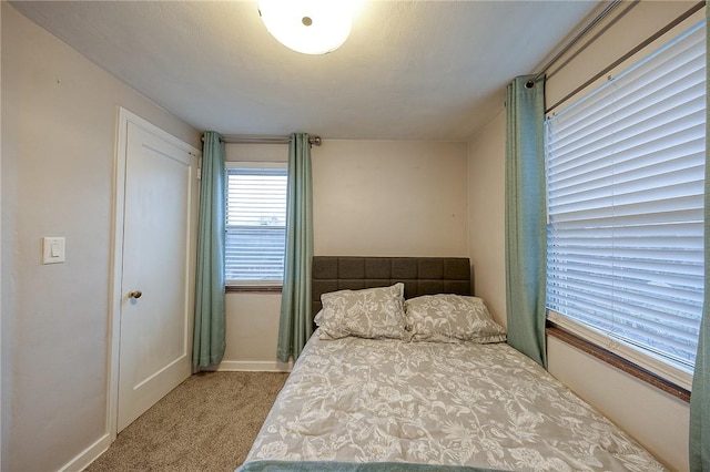 bedroom featuring carpet flooring and baseboards