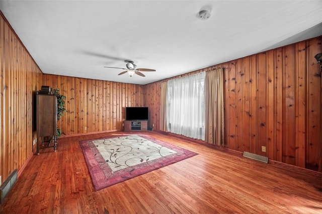 unfurnished living room featuring ceiling fan, wood finished floors, and visible vents