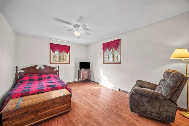 bedroom with baseboards, a ceiling fan, and wood finished floors