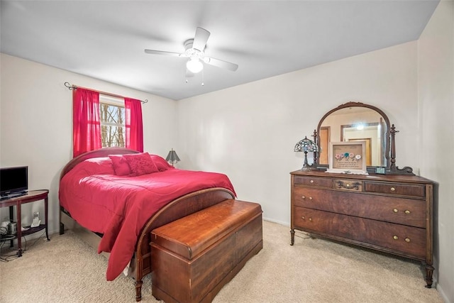 bedroom featuring baseboards, a ceiling fan, and light colored carpet