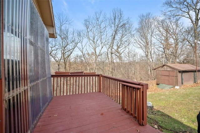 wooden deck with a lawn and an outdoor structure