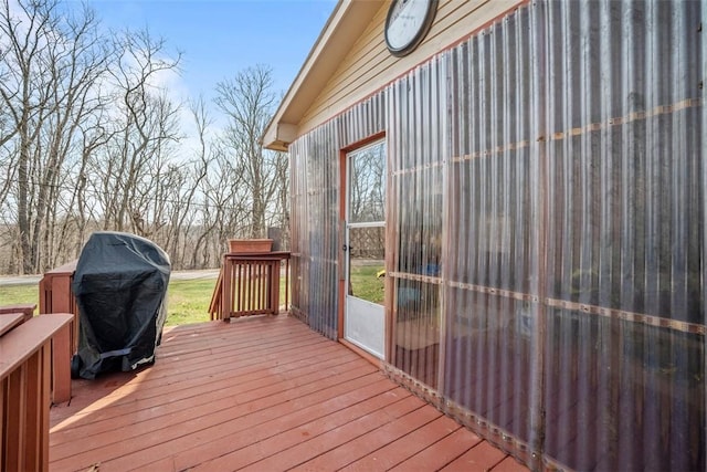 wooden deck featuring a grill