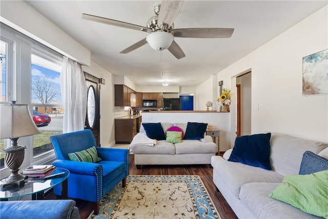 living room with ceiling fan, plenty of natural light, and wood finished floors