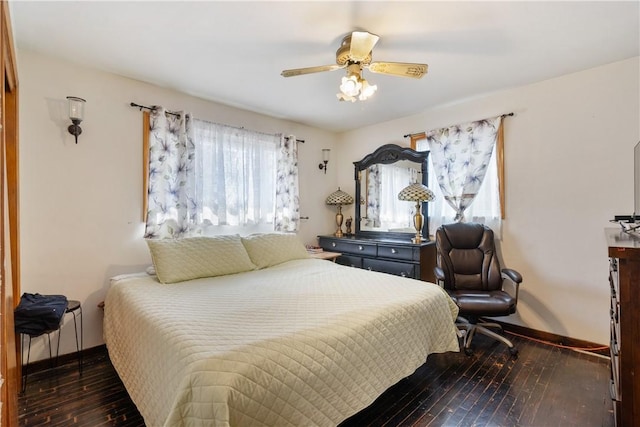 bedroom with wood-type flooring, a ceiling fan, and baseboards