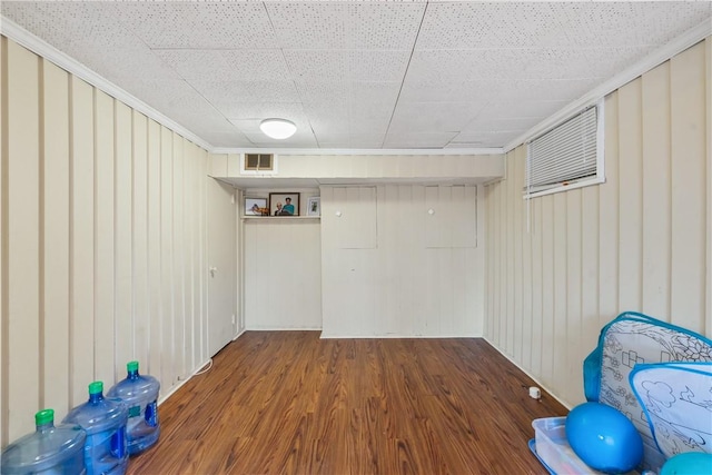 finished basement featuring visible vents and wood finished floors