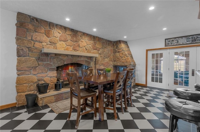 dining space featuring recessed lighting, a fireplace, baseboards, french doors, and tile patterned floors