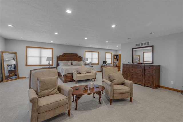 bedroom featuring multiple windows, visible vents, and light colored carpet