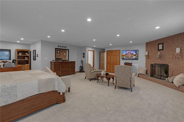 bedroom with recessed lighting, a brick fireplace, visible vents, and light carpet