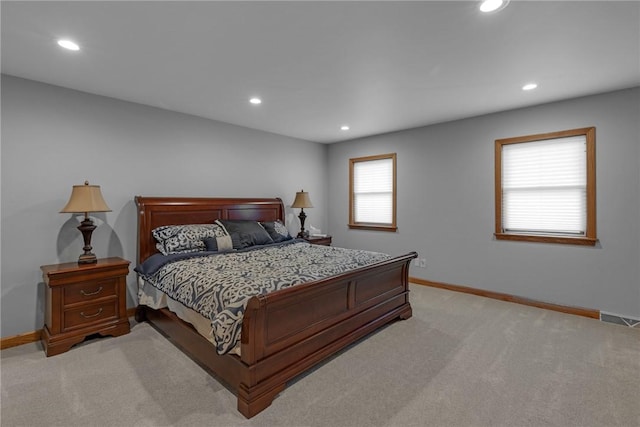 bedroom with baseboards, visible vents, light colored carpet, and recessed lighting