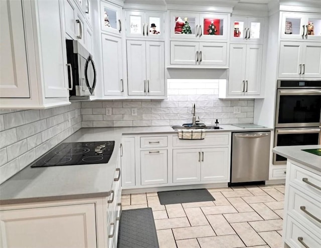 kitchen featuring white cabinets, stainless steel appliances, and light countertops