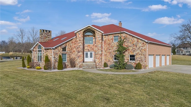 view of front facade with a garage, driveway, french doors, a front lawn, and a chimney