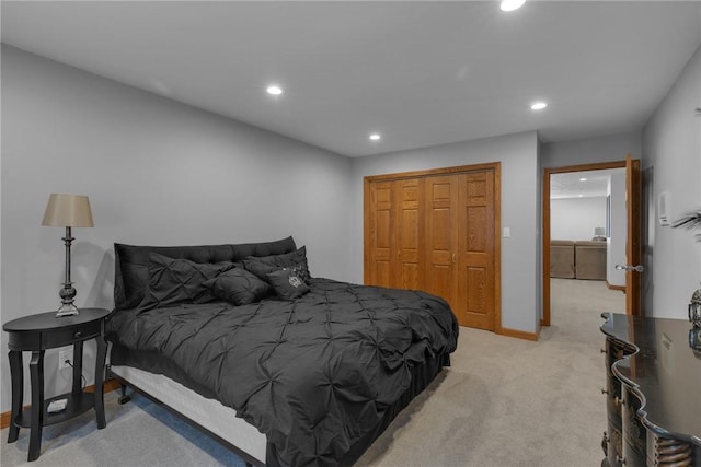 bedroom featuring recessed lighting, baseboards, a closet, and light colored carpet